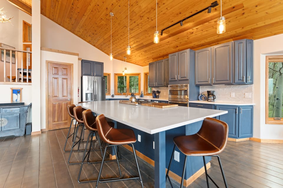Gather around your spacious kitchen island with soaring wood ceilings, modern appliances, and plenty of room for cooking and conversation during your stay.
