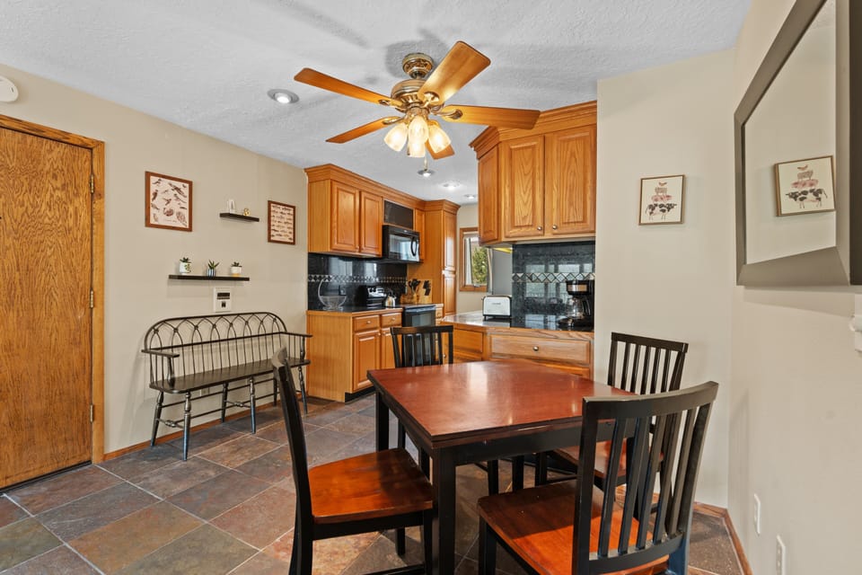 Your spacious kitchen features warm wood cabinetry, modern appliances, and a welcoming dining area where you can share meals with loved ones after a day of adventure.