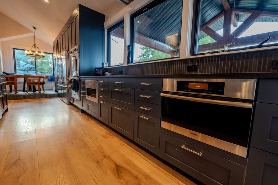 Premium appliances include a double oven, induction cooking, and a steam oven.