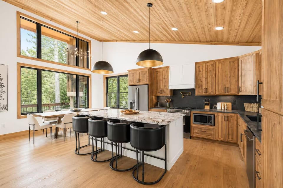 Stunning chef’s kitchen with forest views and a spacious island for 6