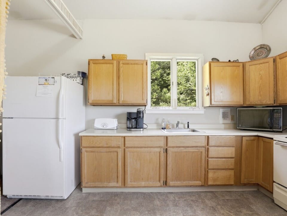 Kitchen | Coffee Maker | White Appliances & Garden Views