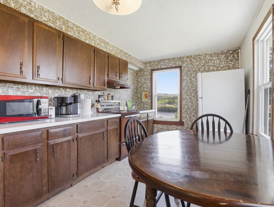 Kitchen | Dark Wood Cabinetry | Dining Area & Country Views