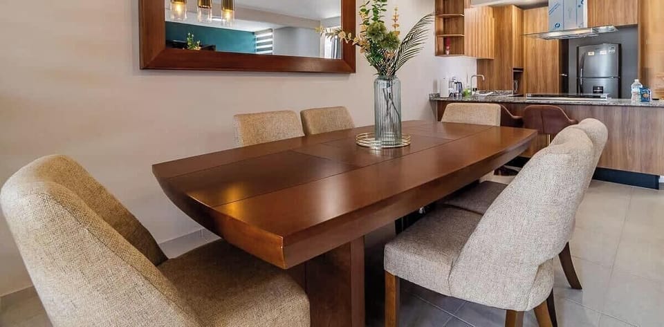 Comedor de madera con sillas acolchadas que brinda confort a la hora de comer.