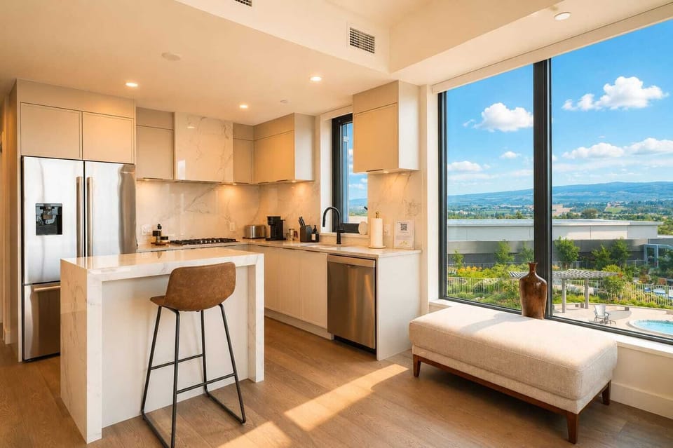 Modern view-filled kitchen with island seating and sunny window bench