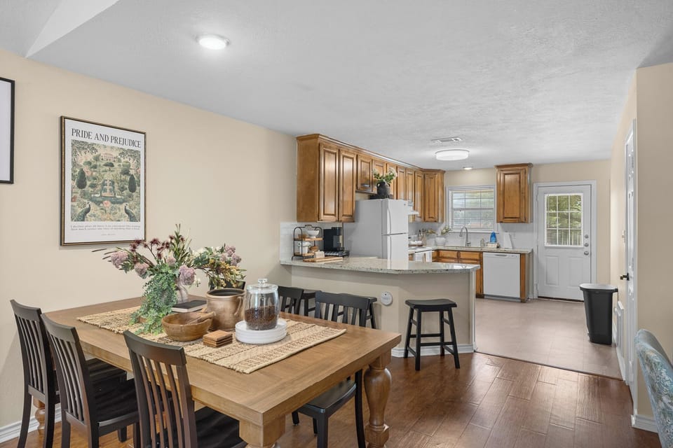 Bright open kitchen and dining area with breakfast bar seating