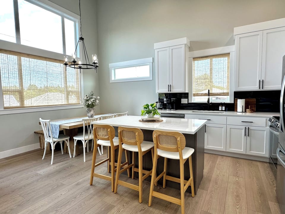 Dining table and island seating side by side, so the whole group eats in one place and the cook is never left out.