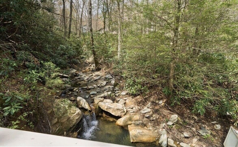 View from lower deck, creek and waterfall on property