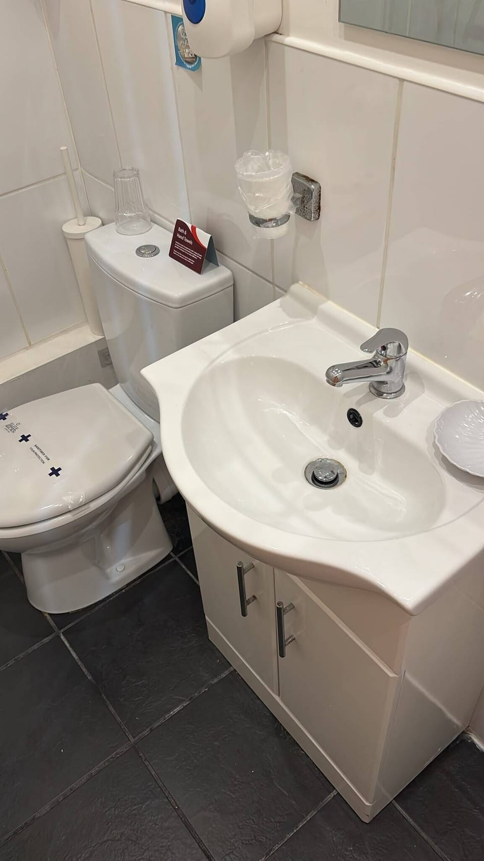 Bright, spotless bathroom with modern vanity and sleek tiled flooring
