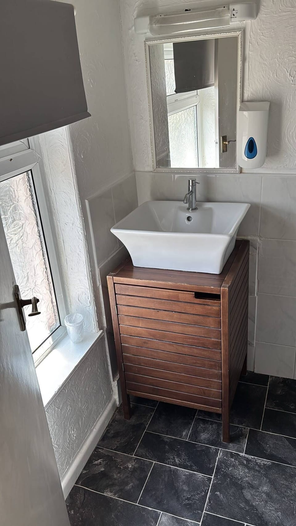Bright modern vanity with natural light and stylish wood accents