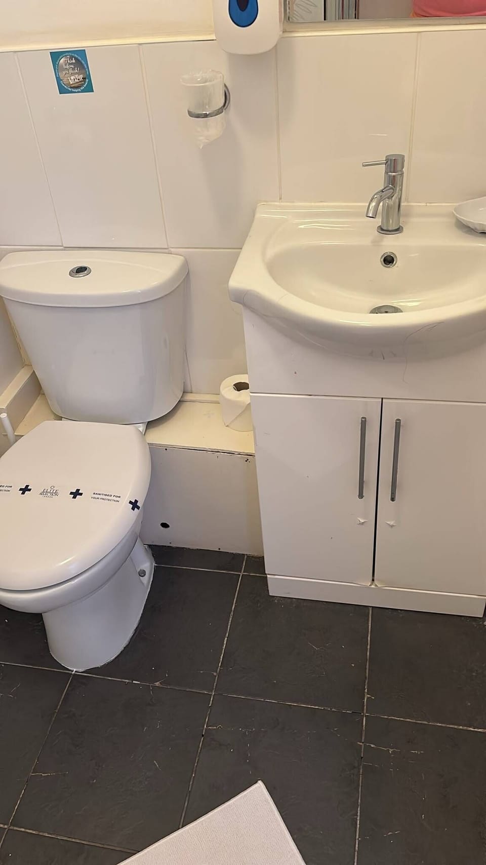 Compact, bright bathroom with vanity storage and modern fixtures