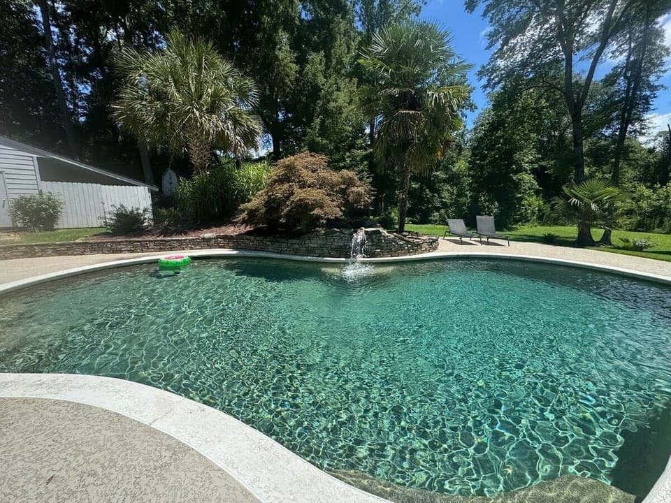 Shared pool and landscaped grounds at Chef’s Château in Griffin, Georgia