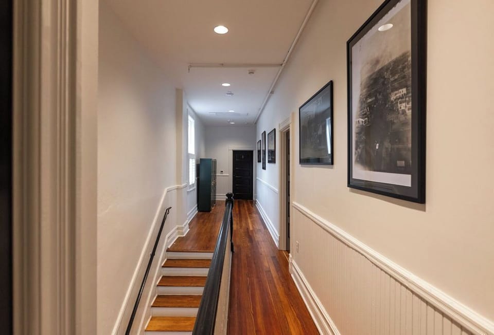 Charming hallway with hardwood floors, art accents, and classic detailing