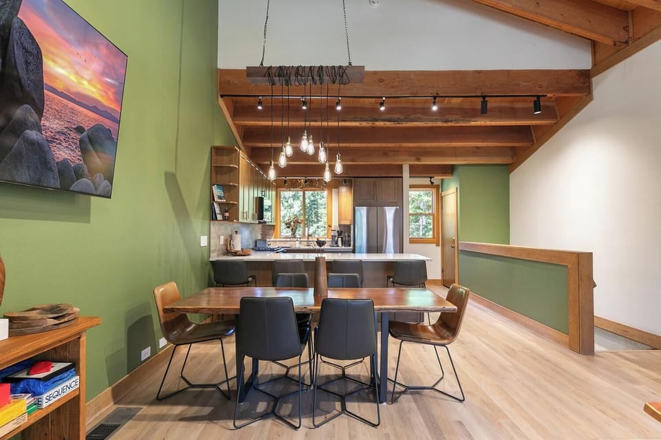 Open dining and kitchen space with vaulted beams and warm modern style