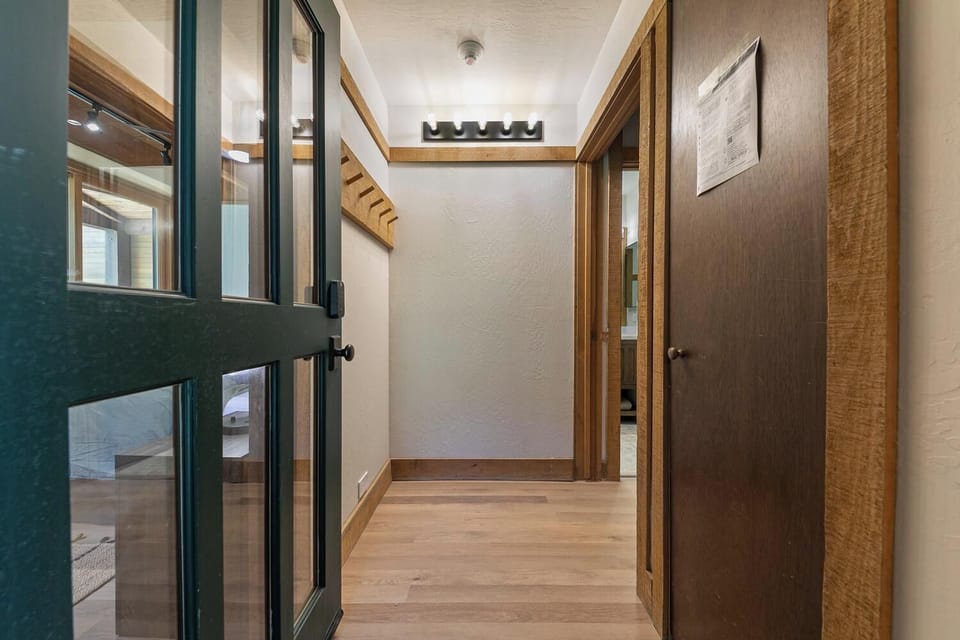 Warm rustic entryway with coat hooks and convenient guest storage