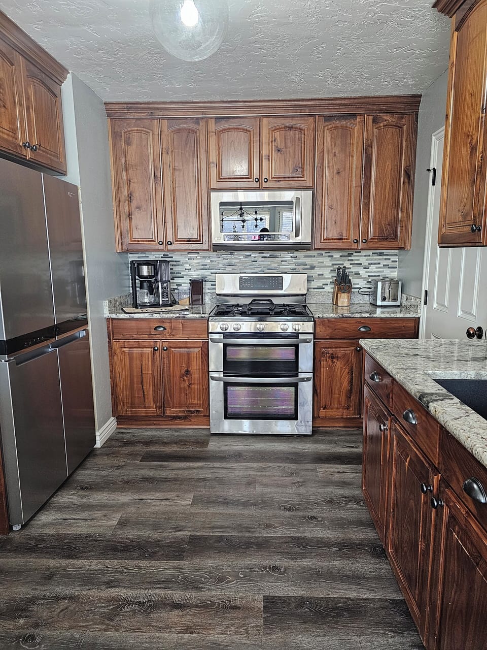 microwave, coffee, stove, refrigerator, toaster, and garage door entry.