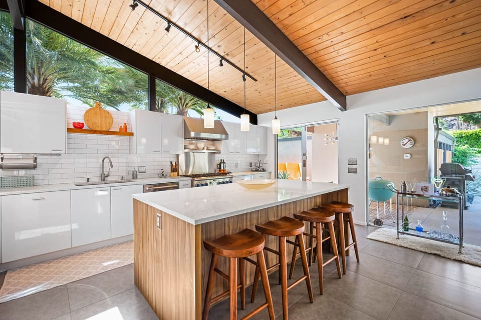 Your stunning modern kitchen awaits with sleek white countertops, warm wood accents, and a spacious island perfect for morning coffee or evening conversations.