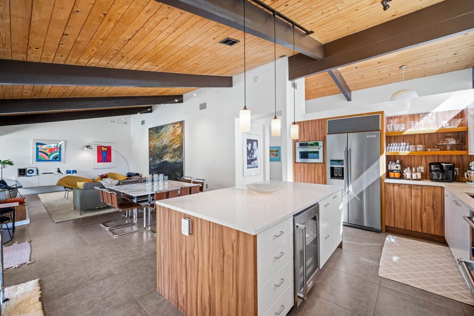 Cook in your sleek kitchen with warm wood accents and gleaming countertops, then gather in the open living space for memorable meals together.