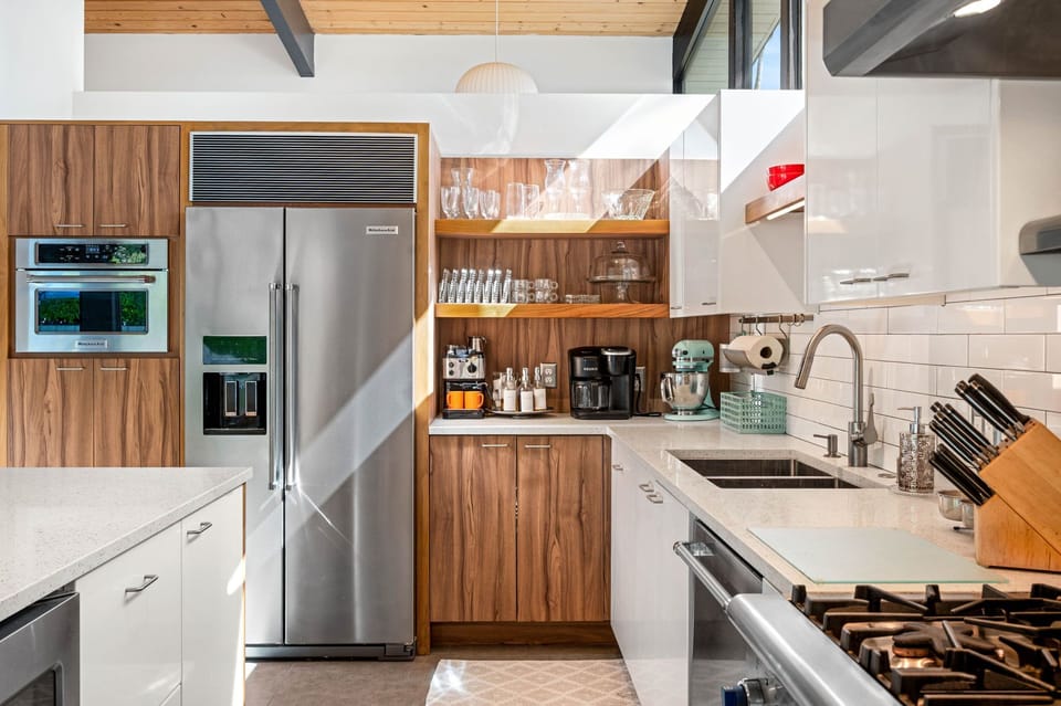 Cook your favorite meals in this sleek modern kitchen with premium appliances, abundant counter space, and everything you need for a perfect stay.