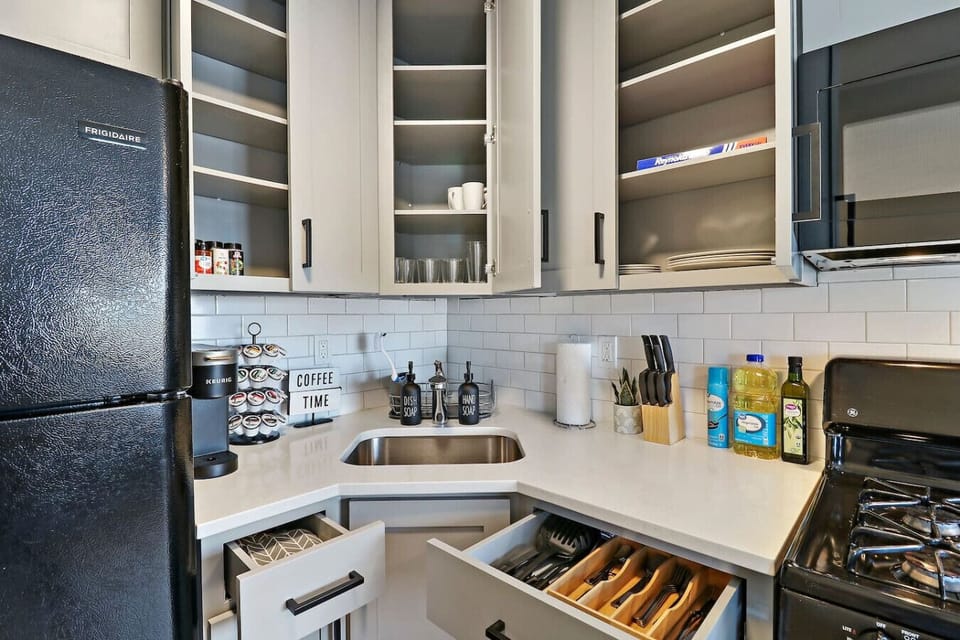 This kitchen is fully stocked with cookware, utensils, and appliances, making it easy to prepare your favorite meals.