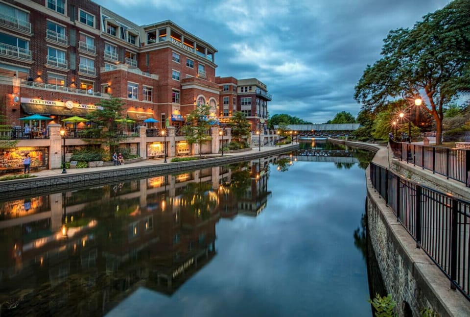 The charming architecture and serene river setting create a picturesque scene.