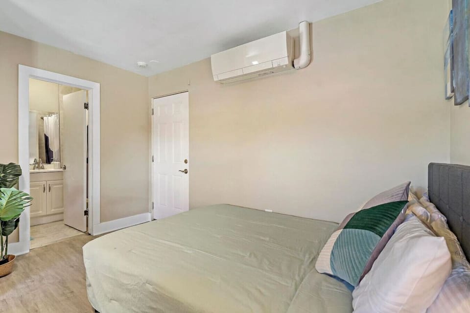 This comfortable bed features soft linens and plush decorative pillows.
