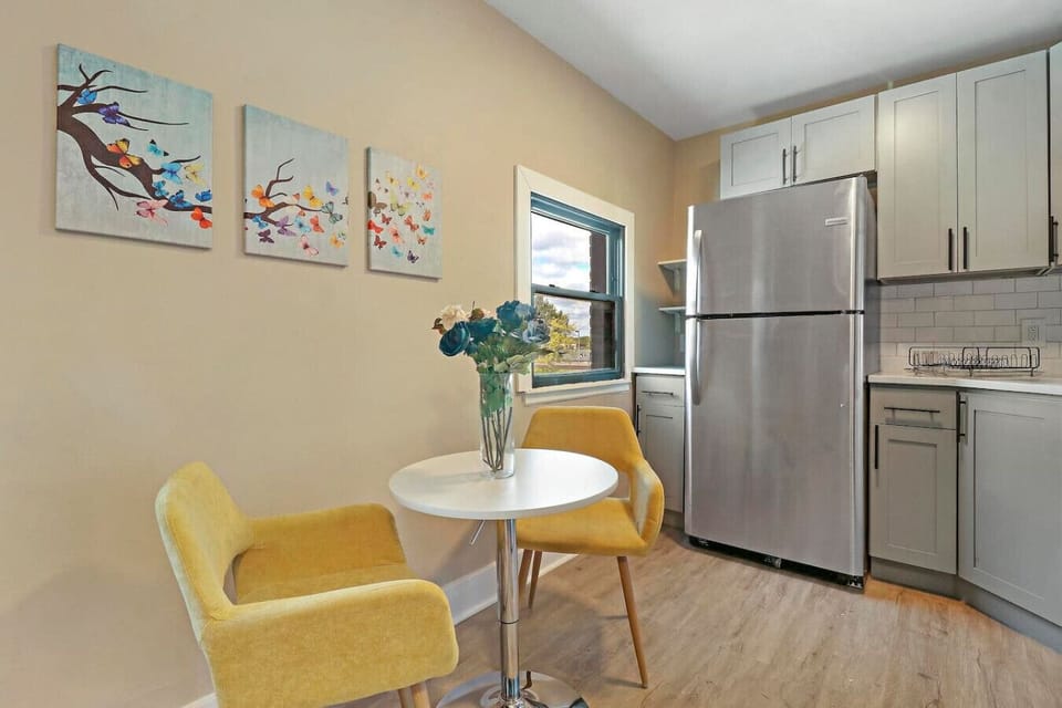 This dining area features a small table and two comfortable chairs, ideal for enjoying meals or a morning coffee.
