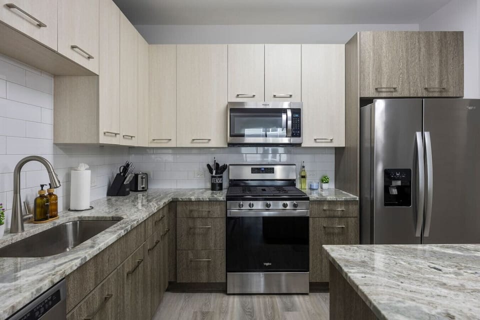 This stylish space features a fully equipped kitchen with stainless steel appliances.