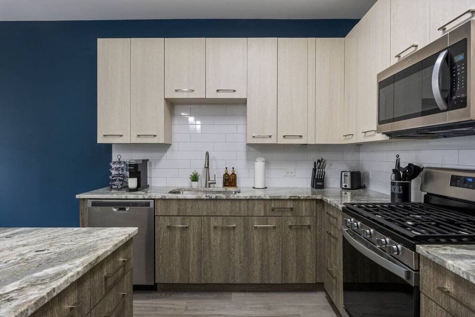 This stylish space features a fully equipped kitchen with stainless steel appliances.