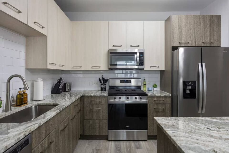 This stylish space features a fully equipped kitchen with stainless steel appliances.