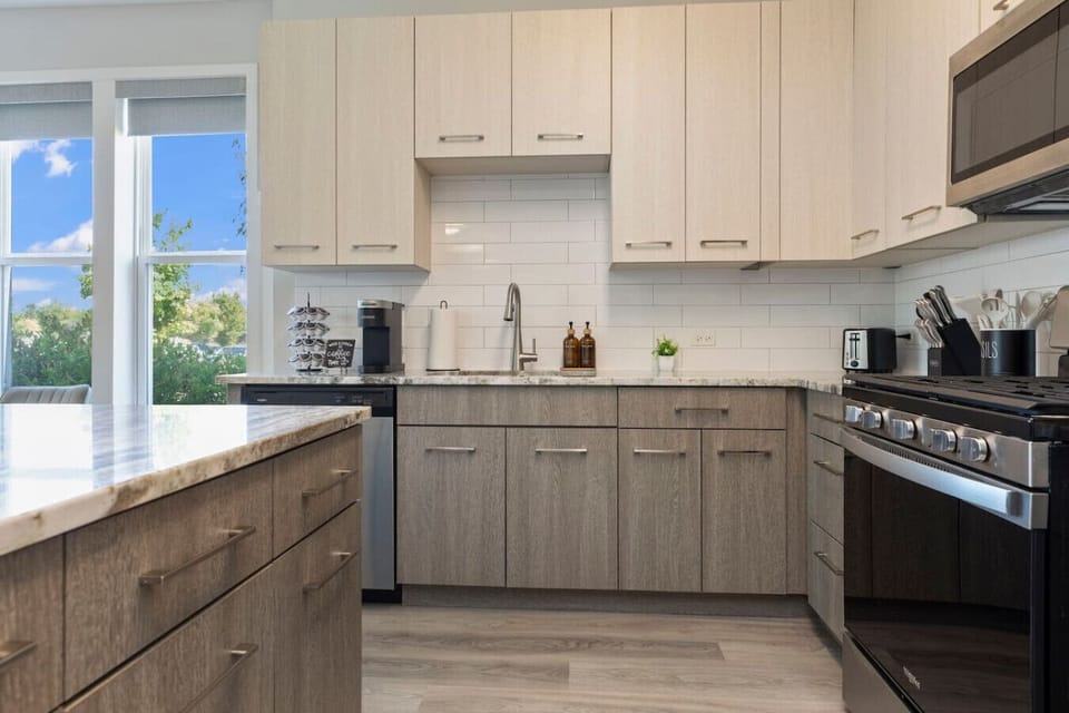 This stylish space features a fully equipped kitchen with stainless steel appliances.