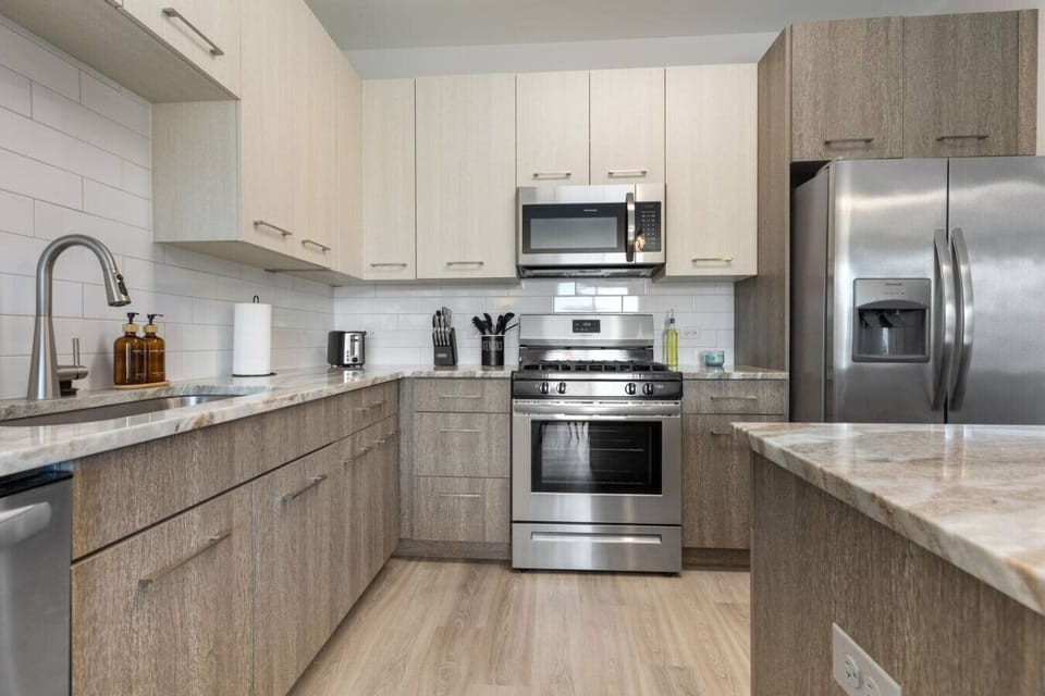 This stylish space features a fully equipped kitchen with stainless steel appliances.