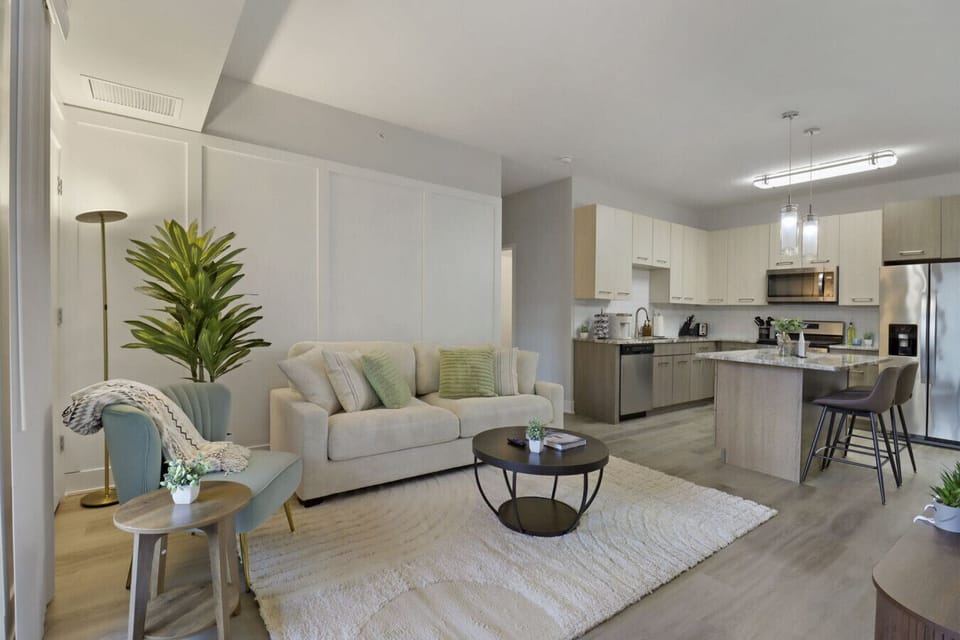 Stylish living room with a smart TV, comfortable seating, and a dedicated dining area for evening entertainment.