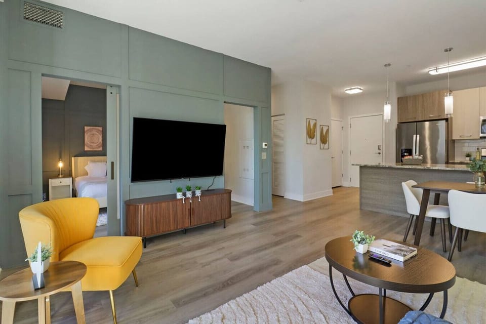 Open plan area with living room, dining table and kitchen.