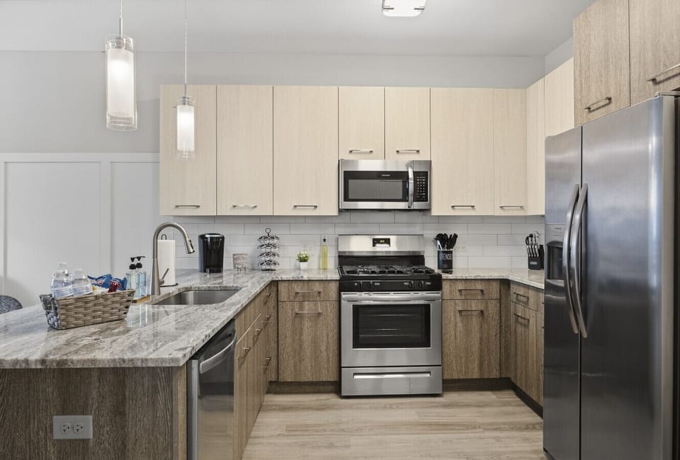 This stylish space features a fully equipped kitchen with stainless steel appliances.