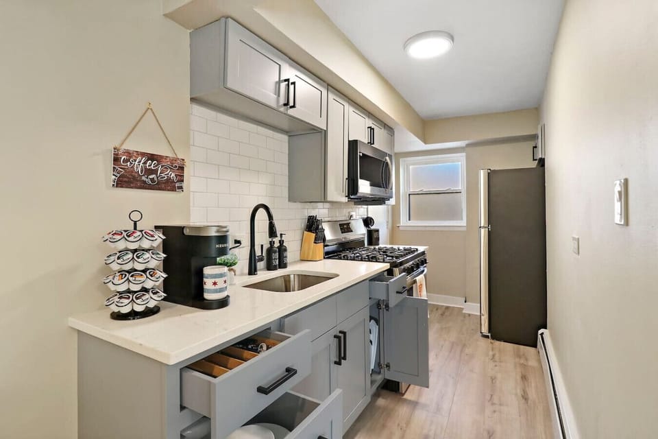 Start your day with a fresh cup of coffee from our convenient coffee bar in this fully equipped kitchen.