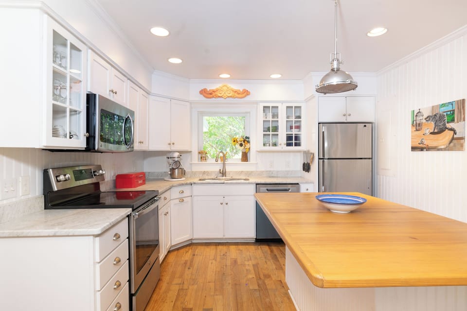 Your bright, fully-equipped kitchen invites you to whip up home-cooked meals with ease. Gleaming counters, a spacious island, and stainless appliances make cooking a joy.