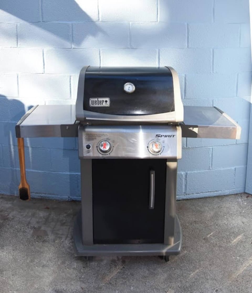 Weber gas grill with prep shelves for easy outdoor BBQ nights