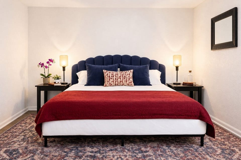 Cozy bedroom with plush blue headboard and warm, inviting accents