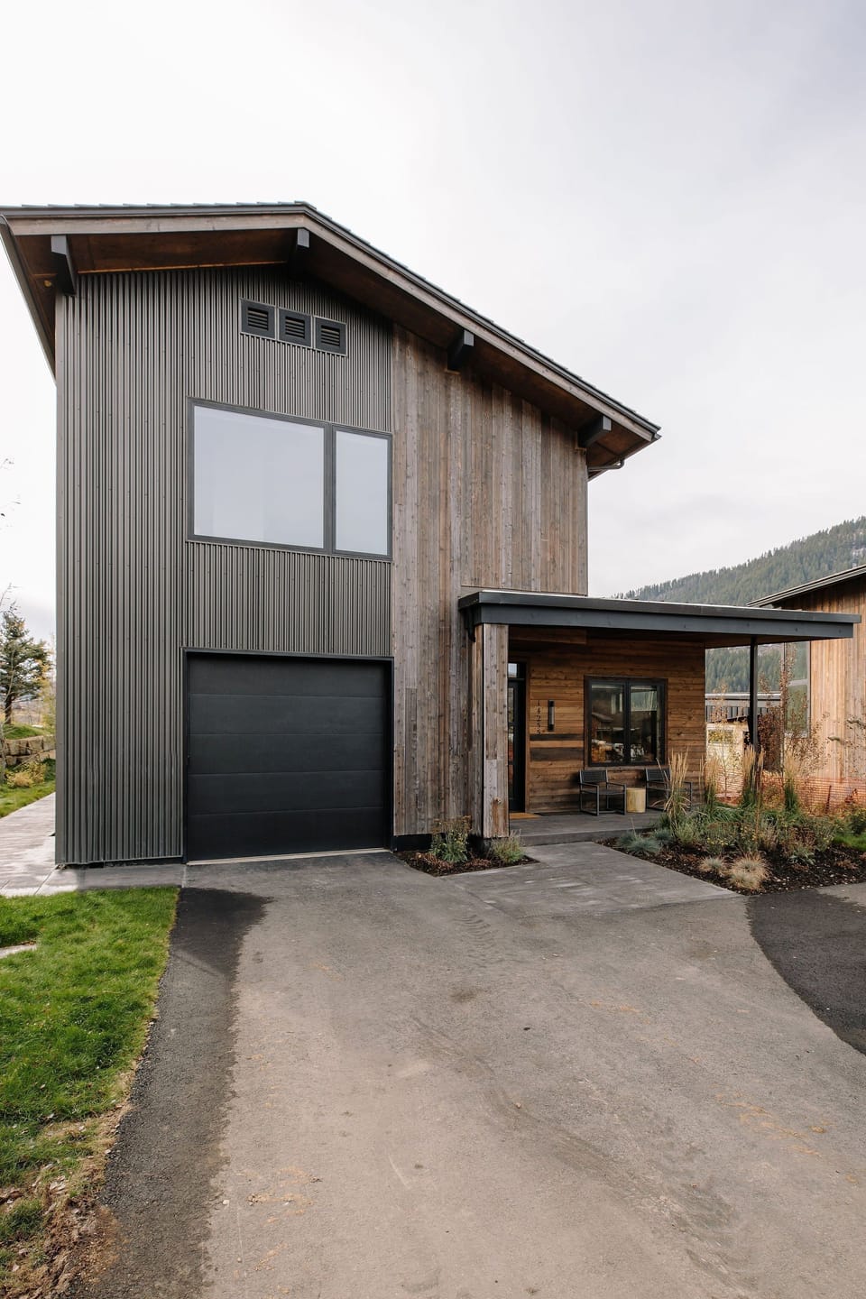 Two-story cabin exterior with wood and metal siding