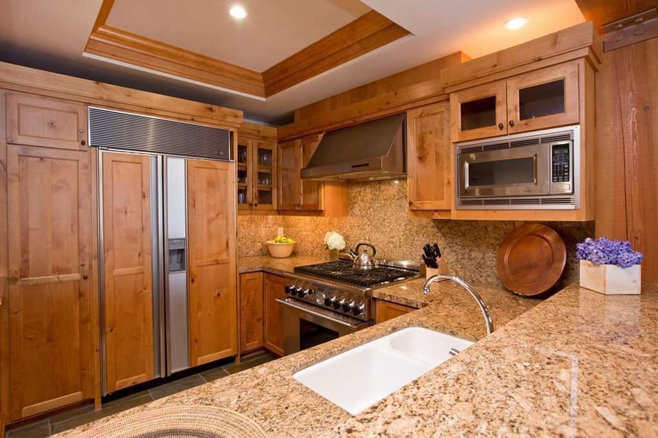 Full kitchen with granite countertops and stainless steel appliances.