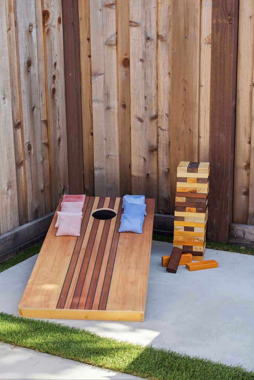 Backyard game zone with cornhole and giant Jenga fun!