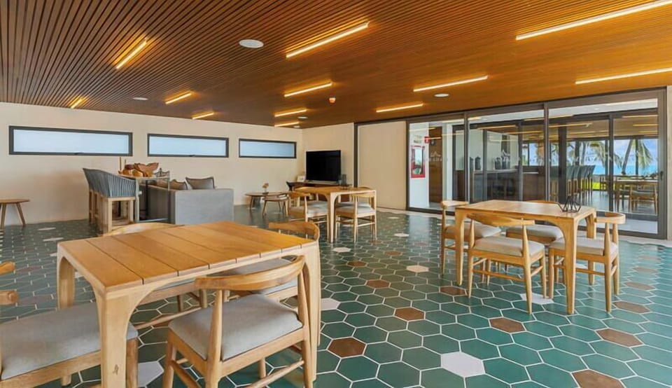 Enjoy a vibrant social environment! This airy clubhouse space features beautiful mid-century dining tables.