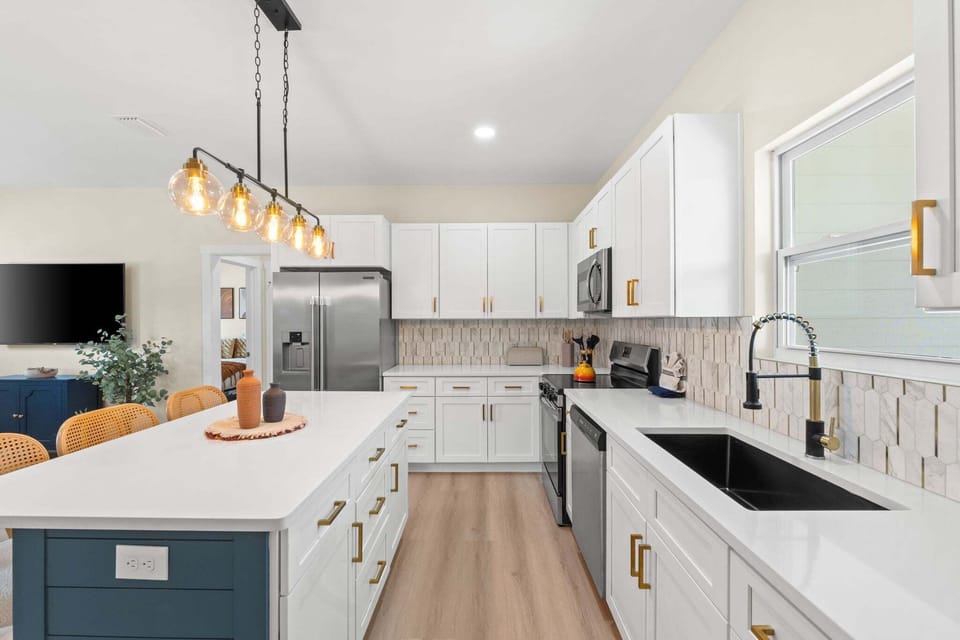 The kitchen features modern appliances and a large window that fills the space with natural light.