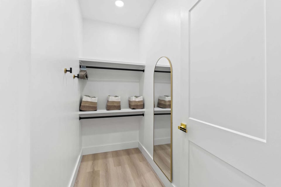 The primary closet offers ample storage space with room for clothing, luggage, and personal items, keeping the suite tidy and organized.