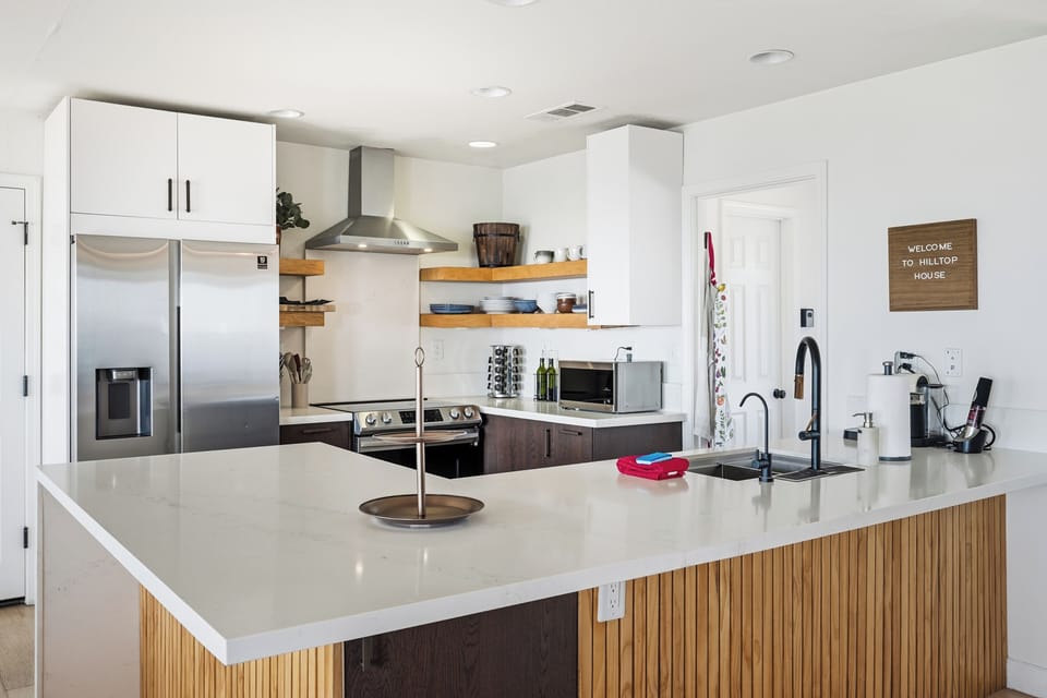 Bright modern kitchen with oversized island and stainless appliances