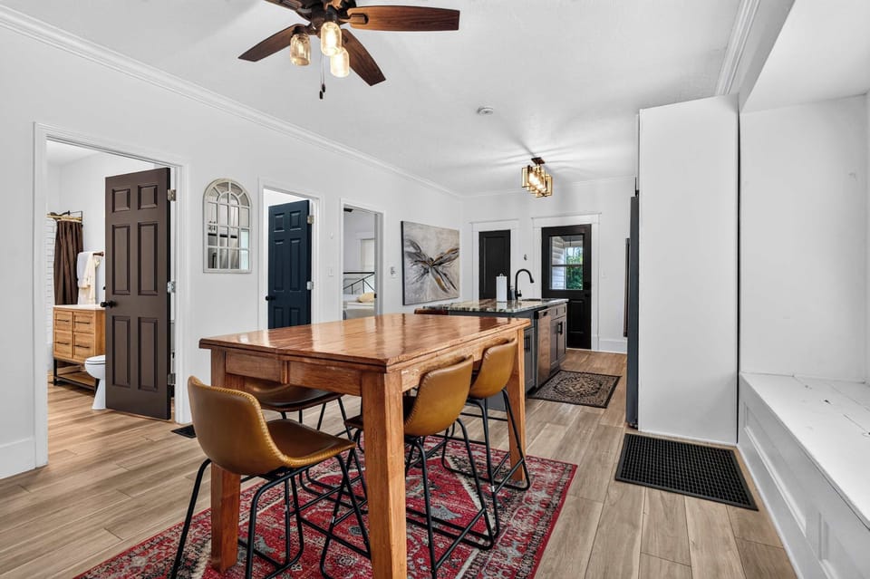 Dining Area: Gather around the inviting dining table for family meals, morning coffee, or game nights in a bright and welcoming space designed for shared moments together.