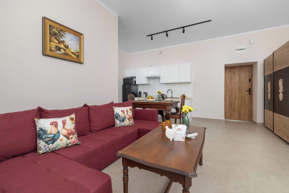 A bright living room with a comfortable sofa and a dining area. A welcoming space to relax after a day of exploring.