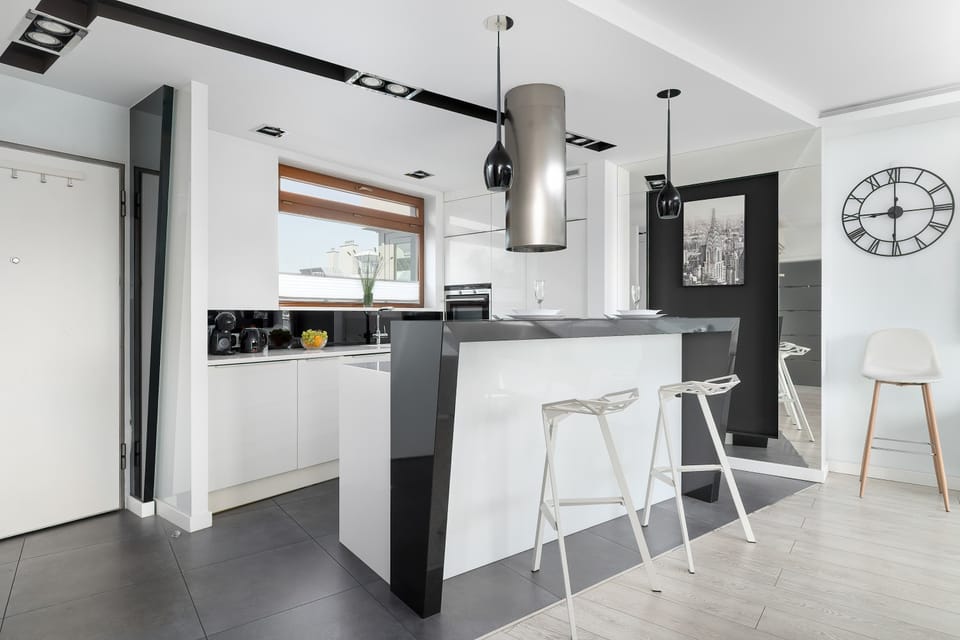 Another view of the open kitchen and dining space. The modern design offers both comfort and functionality.