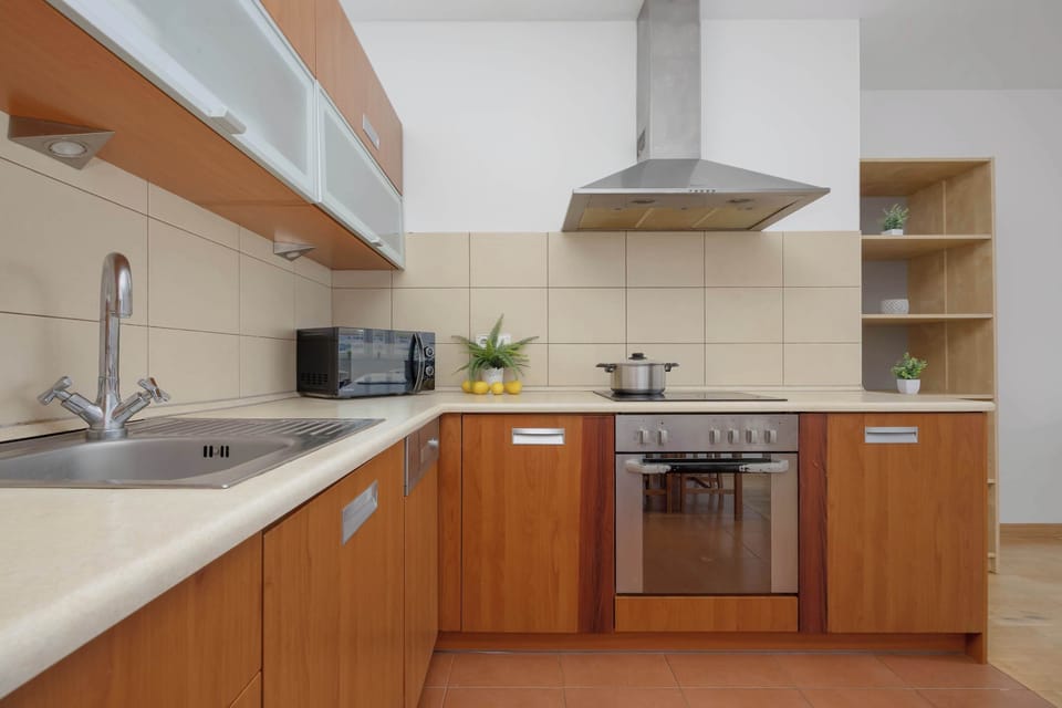 A modern kitchenette equipped with essential appliances and plenty of storage space. Prepare your favorite meals with ease during your stay.
