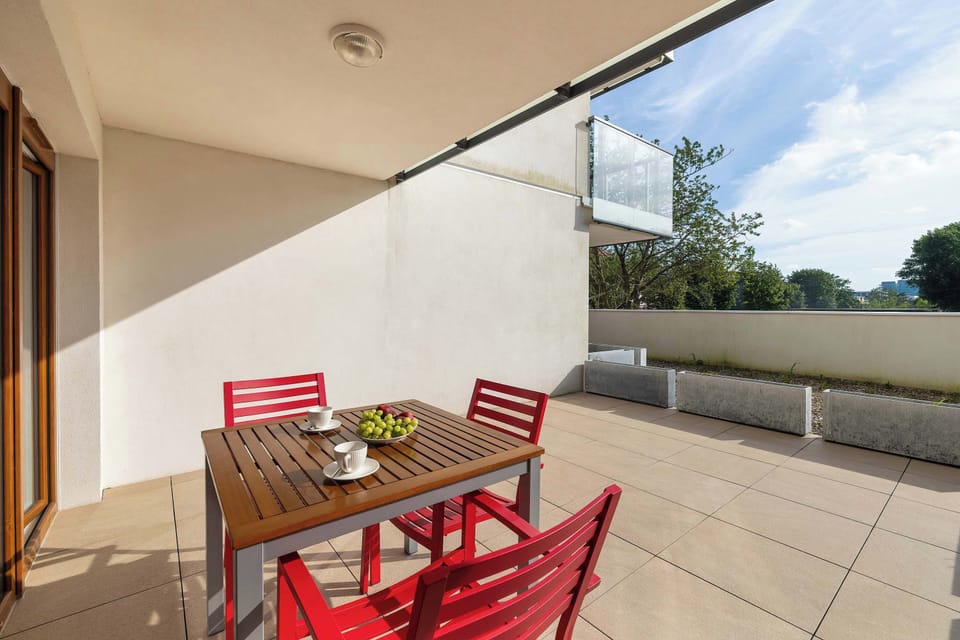 A spacious terrace featuring comfortable seating and a dining area. The outdoor space offers a peaceful place to rest and enjoy the surroundings.